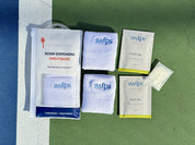 The Swips 2-pack laid out on a pickleball court: retail pouch, two terry cloth sweatbands, two foil sachets and a rosin insert