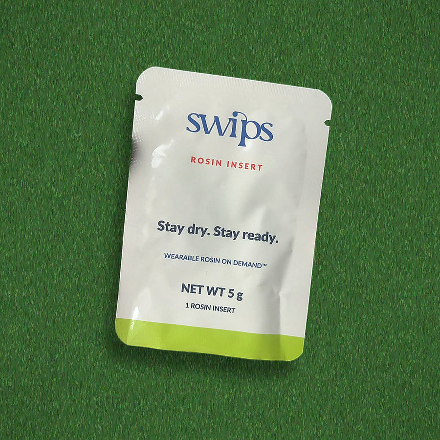 A single sealed Swips rosin insert sachet on turf, Stay dry. Stay ready., net weight 5 g