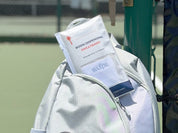 A Swips 2-pack package tucked into a pickleball bag pocket, courtside