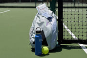 A Swips rosin insert sachet in a pickleball bag at the net, ready for the next game